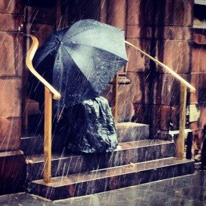 Man With Umbrella on Church Steps